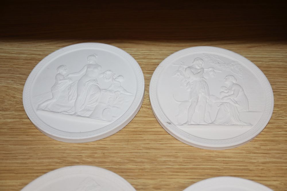 A set of four classical plaster wall plaques, diameter 13.5cm